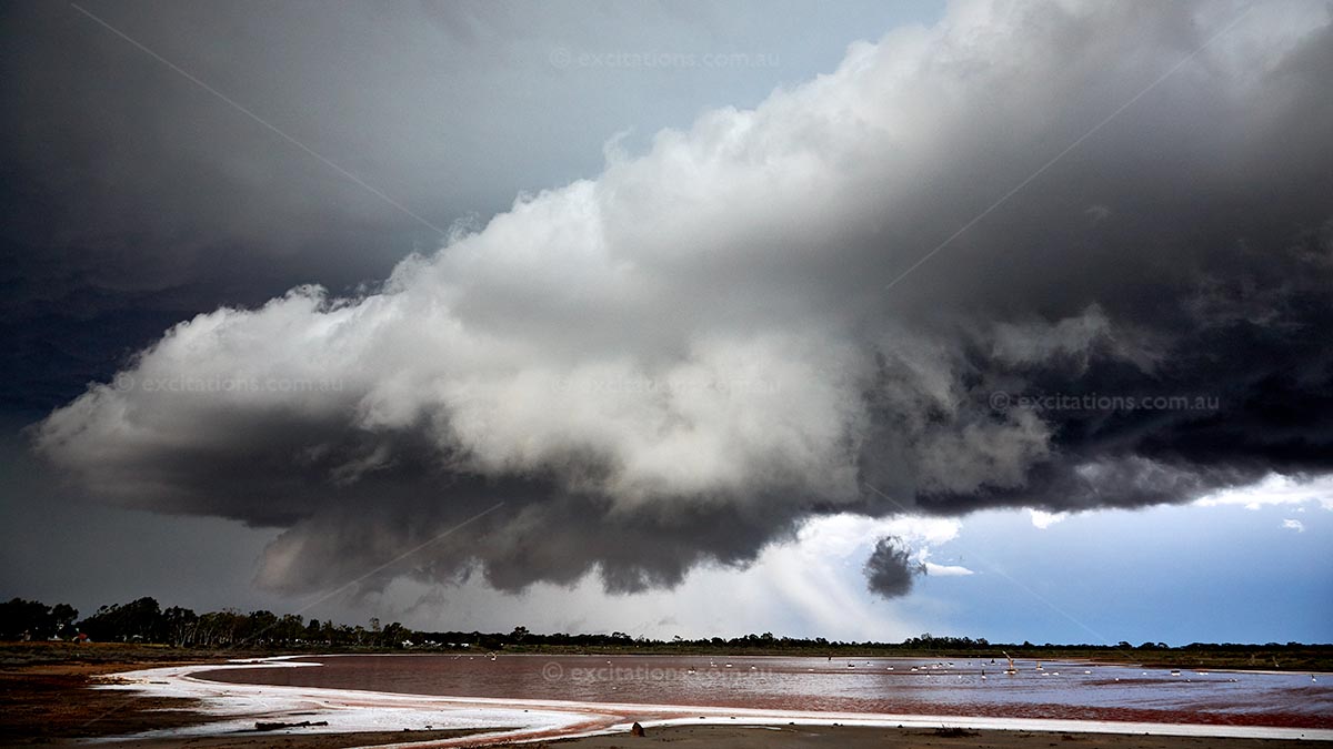 Low level, dramatic storm clouds over salt lake southern Australia. Stock photo by excitations and stock photos Australia